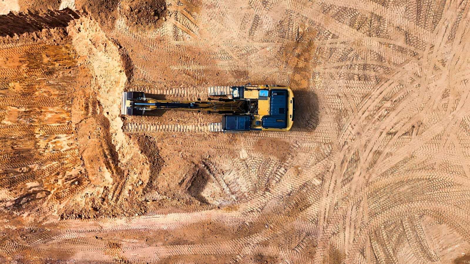 Aerial view of an excavator on a cleared development site