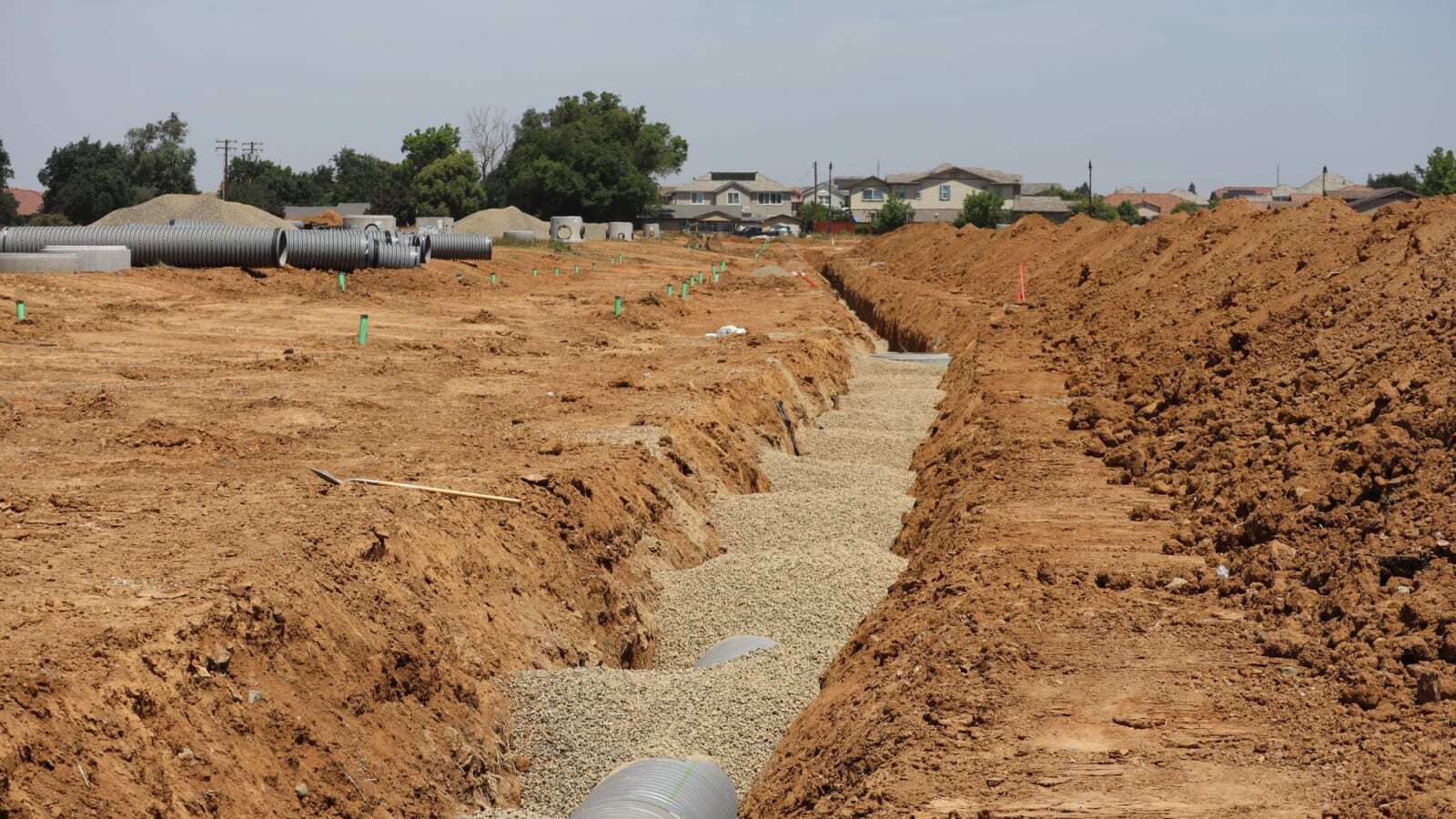 Construction site with trenches and large infrastructure pipes
